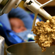 Raw cookie dough clings to the beaters of a standing mixer